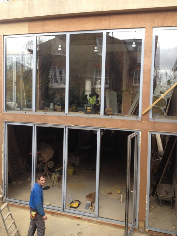 Aluminium bi-fold doors with two-storey glazing in Mill Hill