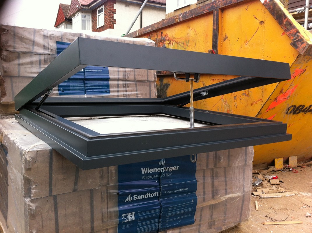Opening flat roof skylight in anthracite grey installed in Mill Hill