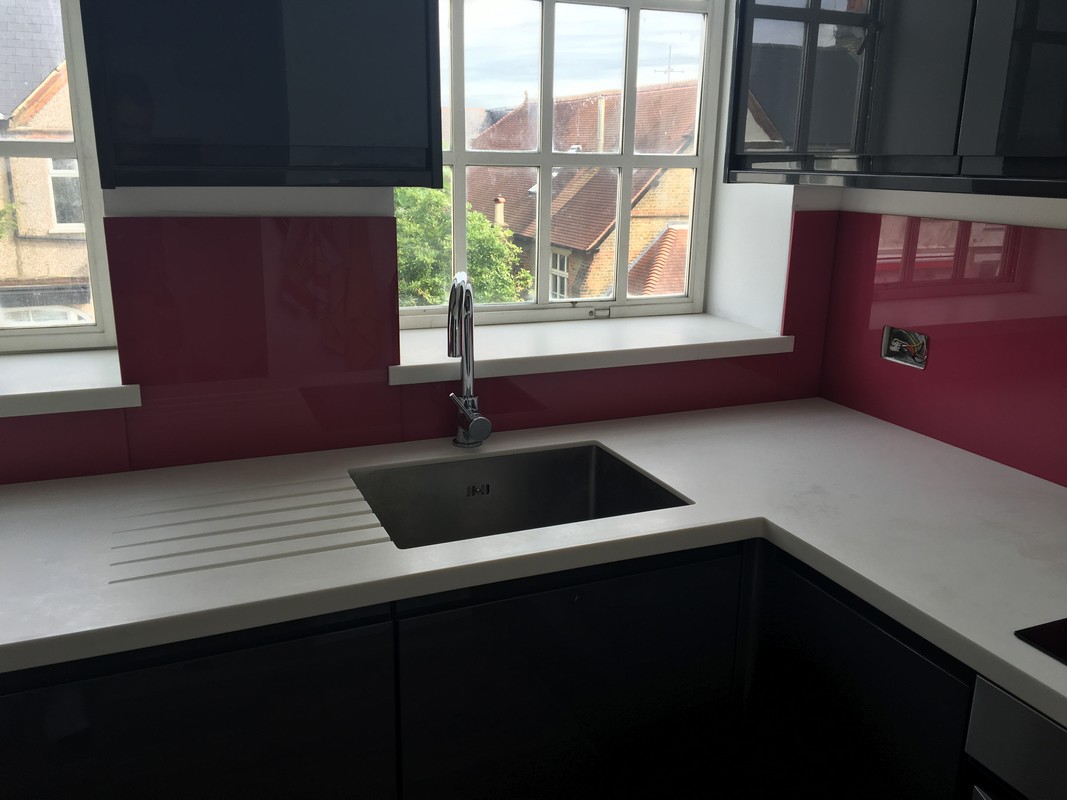 Deep plum coloured glass splashback in modern Mill Hill kitchen